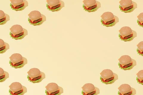 Creative abstract art burger pattern flat lay on pastel yellow background min Stock Photos
