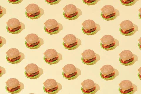 Creative abstract art burger pattern flat lay on pastel yellow background min Stock Photos