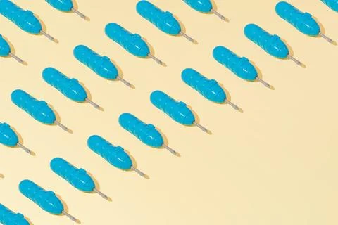 Creative abstract blue screwdriver tool pattern flat lay on yellow background Stock Photos