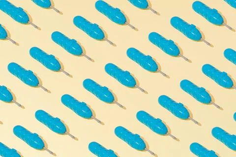 Creative abstract blue screwdriver tool pattern flat lay on yellow background Stock Photos