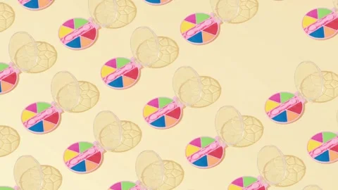 Creative abstract cosmetic makeup eye shadow pattern flat lay yellow background Stock Footage 331716583