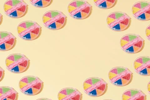 Creative abstract cosmetic makeup eye shadow pattern flat lay yellow copy spa Stock Photos
