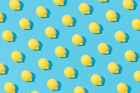 Creative abstract lemon pattern flat lay on pastel blue background minimalism Stock Photos