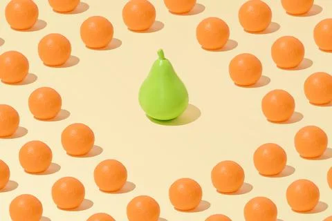 Creative abstract orange and pear pattern flat lay on pastel yellow backgroun Foto stock