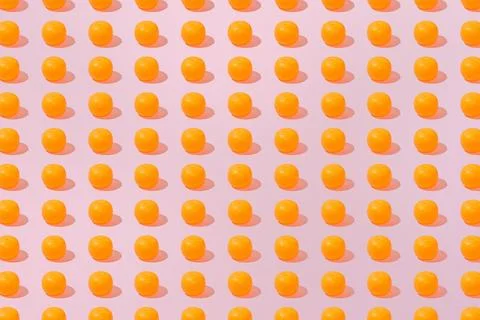 Creative abstract orange pattern flat lay on pastel pink background minimalis Stock Photos