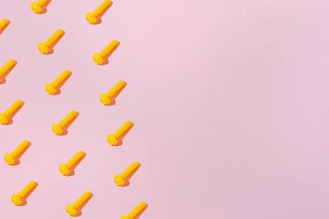 Creative abstract screw pattern flat lay on pastel pink background copy space Stock Photos