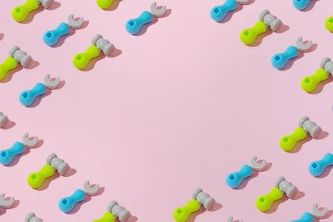 Creative abstract screwdriver and hammer tool pattern flat lay pink backgroun Stock Photos