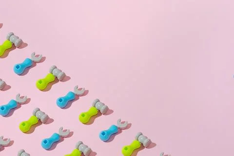 Creative abstract screwdriver and hammer tool pattern flat lay pink backgroun Stock Photos