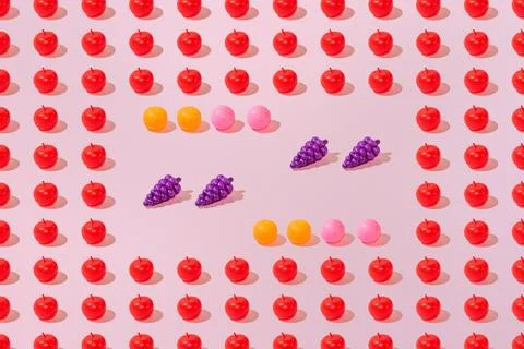 Creative abstract summer apple, grape, peach and orange pattern flat lay on p Stock Photos
