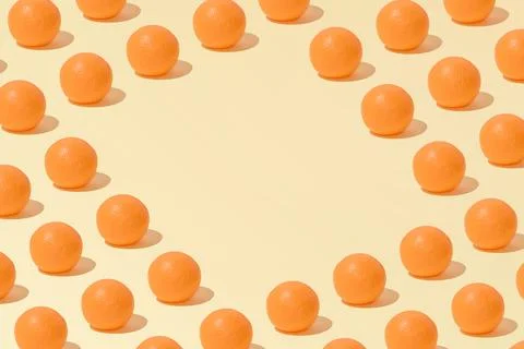 Creative abstract summer orange pattern flat lay on pastel yellow background  스톡 사진