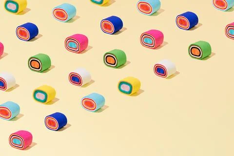 Creative abstract sushi roll pattern flat lay pastel yellow background copy.. Stock Photos