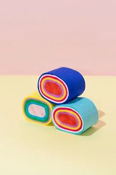 Creative abstract sushi rolls flat lay on pastel pink yellow background conce Stock Photos