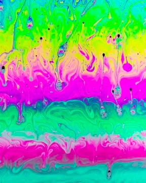 A creative abstract swirling liquid rainbow of colours that looks like waterc Stock Photos