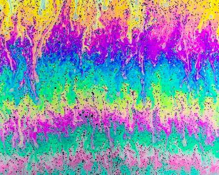 A creative abstract swirling liquid rainbow of colours that looks like waterc Stock Photos