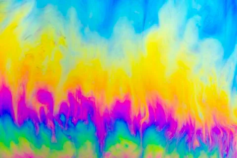 A creative abstract swirling liquid rainbow of colours that looks like waterc Stock Photos
