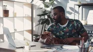Creative African American Man With Glasses Working Laptop Sit With Dog Draw Stock Footage
