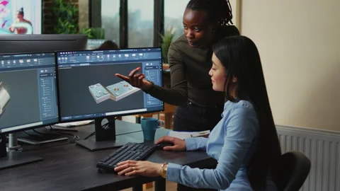 Creative agency diverse team editing video footage using color grading Stock Footage 229815503