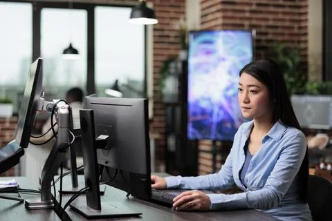 Creative agency employee working on developing digital project while sitting at 写真素材