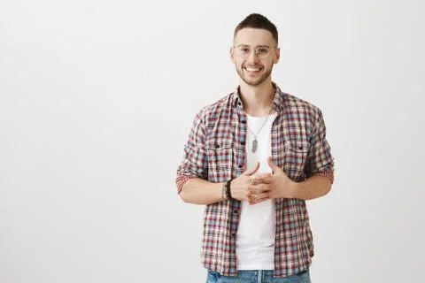 Creative and handsome stylish guy with bristle, clasping hands while smiling Foto stock