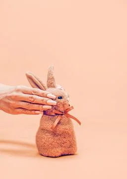 A creative and unusual Easter concept. Female hands hide the eyes Stock Photos