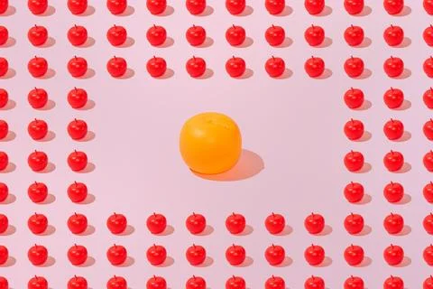 Creative apple and orange pattern flat lay on pastel pink background minimali Stock Photos