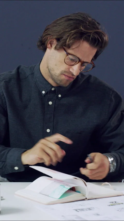 Creative, architect and man with notebook, office and plan for design project or Stock Footage 329838234