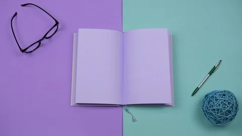 Creative, art and wright concept. Pastel violet book isolated on a two colored Stock Footage 129151919