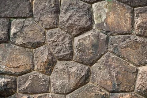 Creative art background of large brown stone boulders in an ancient wall with Stock Photos