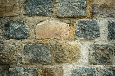 Creative art background from an old wall with stonework in a row of multi-col Stock Photos
