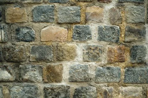 Creative art background from an old wall with stonework in a row of multi-col Stock Photos