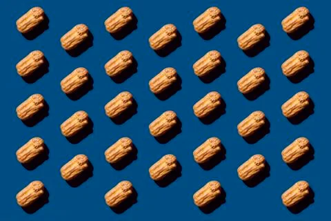 Creative art with Eclair pattern on classic blue background.Isometric flat la Stock Photos