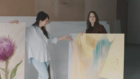 Creative artist showcases large abstract painting in modern studio space Stock Footage 322059999
