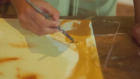 Creative Artist at Work with Brush Strokes on Canvas in Vibrant Studio 動画素材 333418033