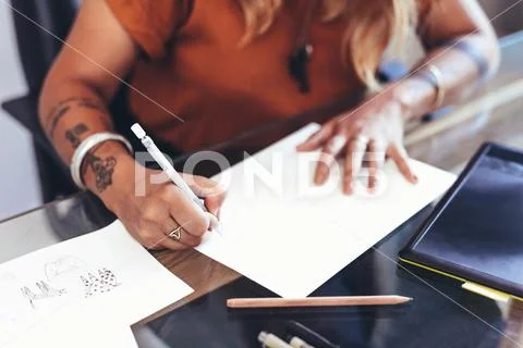 Creative artist at work sitting at her desk Stock Photos