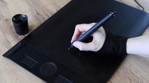 Creative artist's hand draw with a digital pen on a graphics tablet at a mo.. Stock Footage 339018352