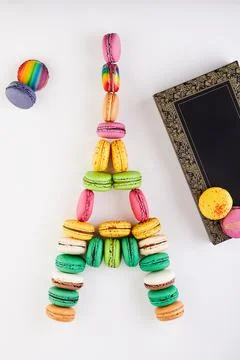 Creative arts display Eiffel tower macaron art next to a notebook Stock Photos