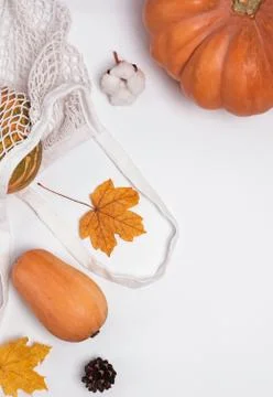 Creative autumn composition with pumpkins and dry leaves on white background Stock Photos