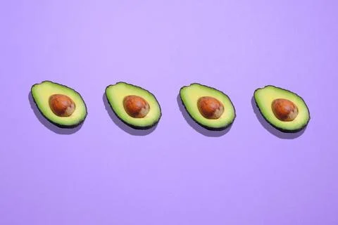 Creative avocado pattern on a purple background with a space for text Stockfoto's