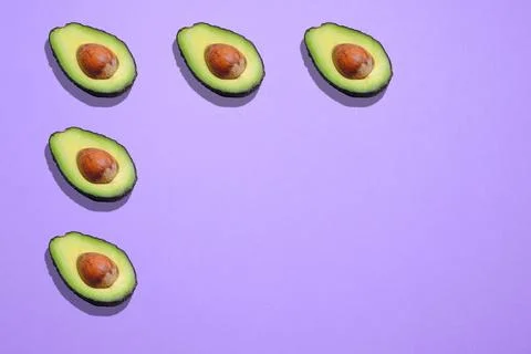 Creative avocado pattern on a purple background with a space for text Foto stock