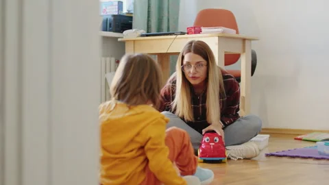 A creative babysitter comes up with a fun game to play with a little boy in the Stock Footage 272537628