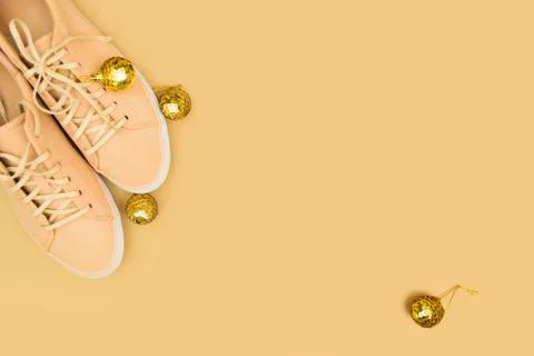 Creative backdrop for winter time. Shoe store with beige sneakers and decoration Stock Photos
