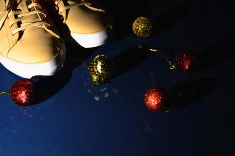 Creative backdrop for winter time. Shoe store with beige sneakers and decoration Stock-Fotos