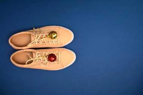 Creative backdrop for winter time. Shoe store with beige sneakers and decoration Stock Photos