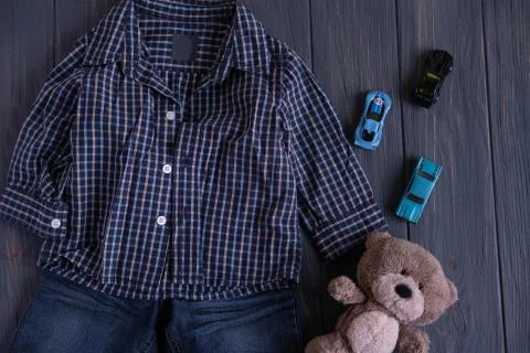 Creative background with jeans and a checkered shirt for a boy one year old. Stock Photos
