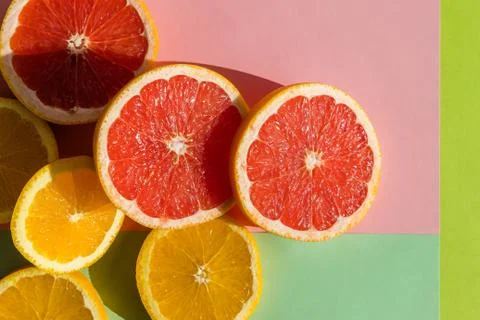 Creative background made of summer tropical fruits, grapefruit, orange, tange Stock Photos