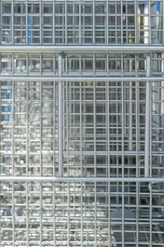 Creative background of metal mesh. Natural structure of stainless steel. Stock Photos