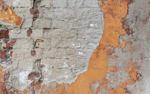 Creative background from an old cracked brick wall with sprinkled cement plas Stock Photos