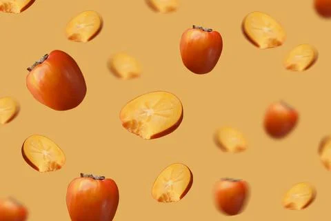 Creative background with persimmon. Levitation, flying persimmon. Stock Photos