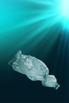 Creative background of PET plastic bottle floating in sea or ocean Stock Photos