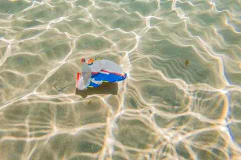 Creative background, plastic bag floating in the ocean, a bag in the water. The Stock Photos